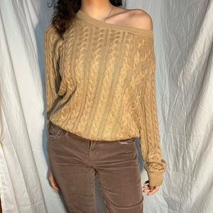 Beige sweater with braid texture.